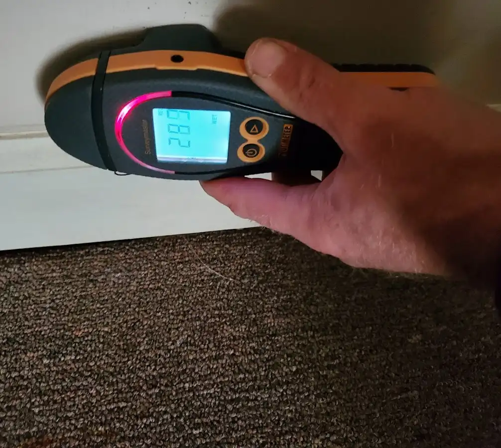 Moisture detection at baseboard during Storm Damage Restoration in Adams